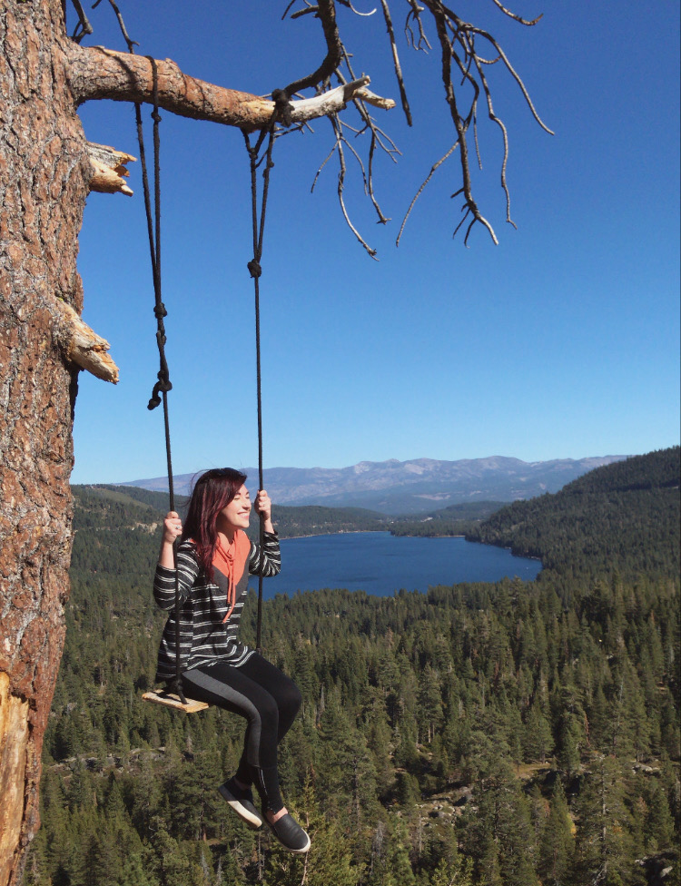 photo of the author swinging over a cliffside in Tahoe